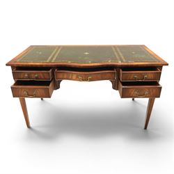 Regency style mahogany writing desk, serpentine front tooled green leather inset, slides to either side, central frieze drawer, flanked by a bank of two drawers, square tapering supports