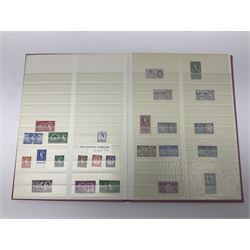 Mostly Great British stamps, including King Edward VII two shillings and sixpence, five shillings and ten shillings, King George V seahorses, King George VI high values, Queen Elizabeth II pre and post decimal etc, housed in a pink stockbook 