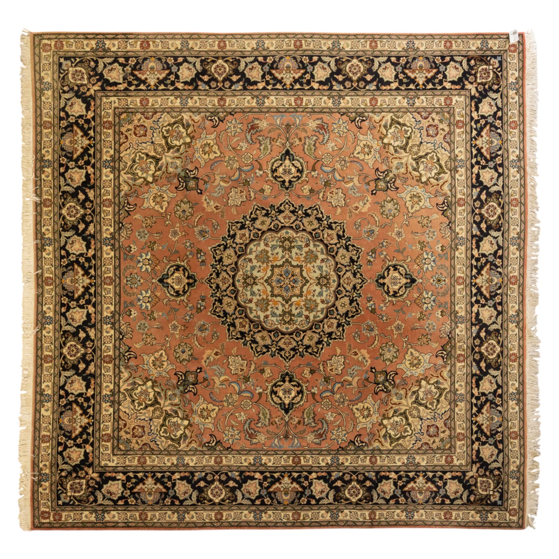 Persian Kashan style rug, salmon pink ground, central conforming lobed medallion in ivory and indigo, with palmette pendants, framed scrolling arabesques of lotus blossoms and palmettes, within navy border of meandering vines and flowerheads between ivory guard stripes 