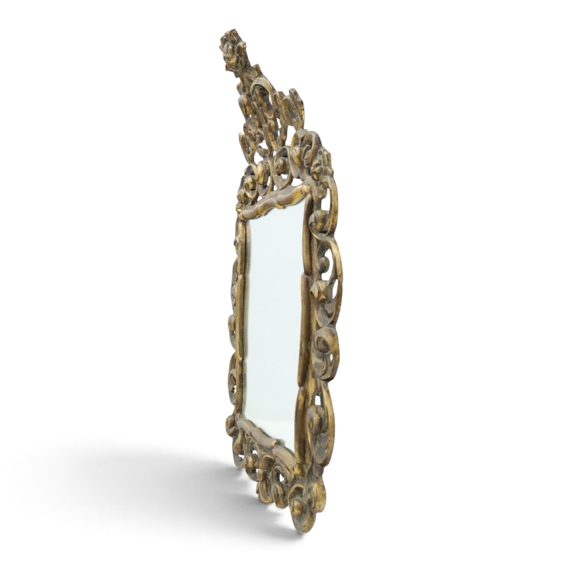 Rococo style gilt wall mirror, the shaped rectangular bevelled plate within a pierced frame of scrolling acanthus leaves, surmounted by a foliate crest