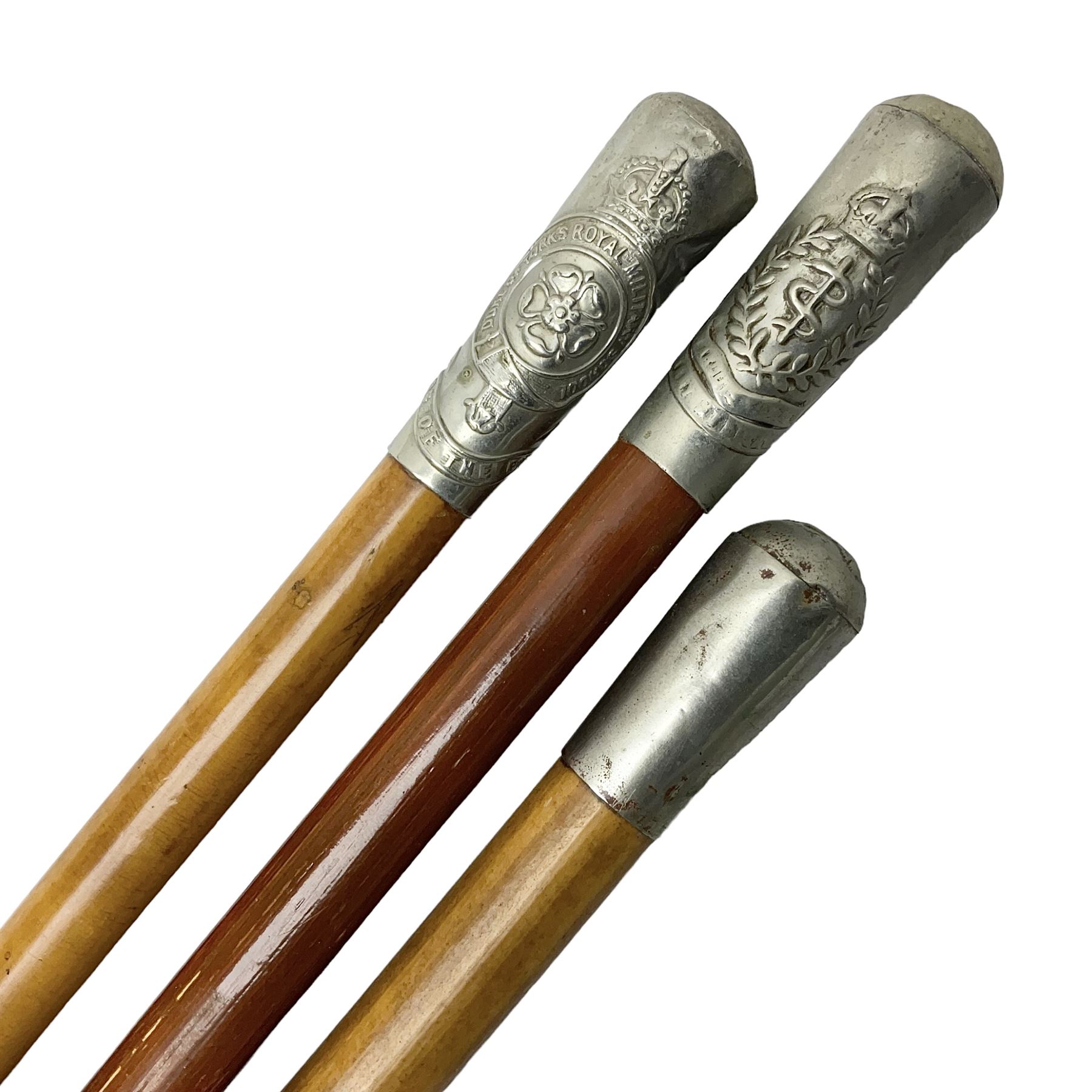 Three malacca cane swagger sticks - Duke of York's Royal military School L68cm; RAMC; and another embossed with a lion to the terminal (3)