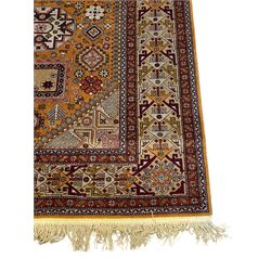 Shirvan Caucasian burnt amber ground carpet, central geometric pole medallion with four flanking octagonal lozenges surrounded by stylised flower heads, the border decorated with repeating geometric plant motifs and guarded by maroon bands