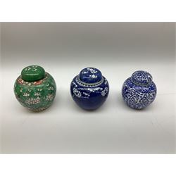 Six Chinese ginger jars, predominantly of blue and white design decorated with blossoming branches, all with lids, housed on various hardwood carved stands, some with character marks beneath