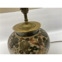 Japanese ceramic table lamp, decorated with flowers and butterflies upon a circular wooden base, with shades H52cm