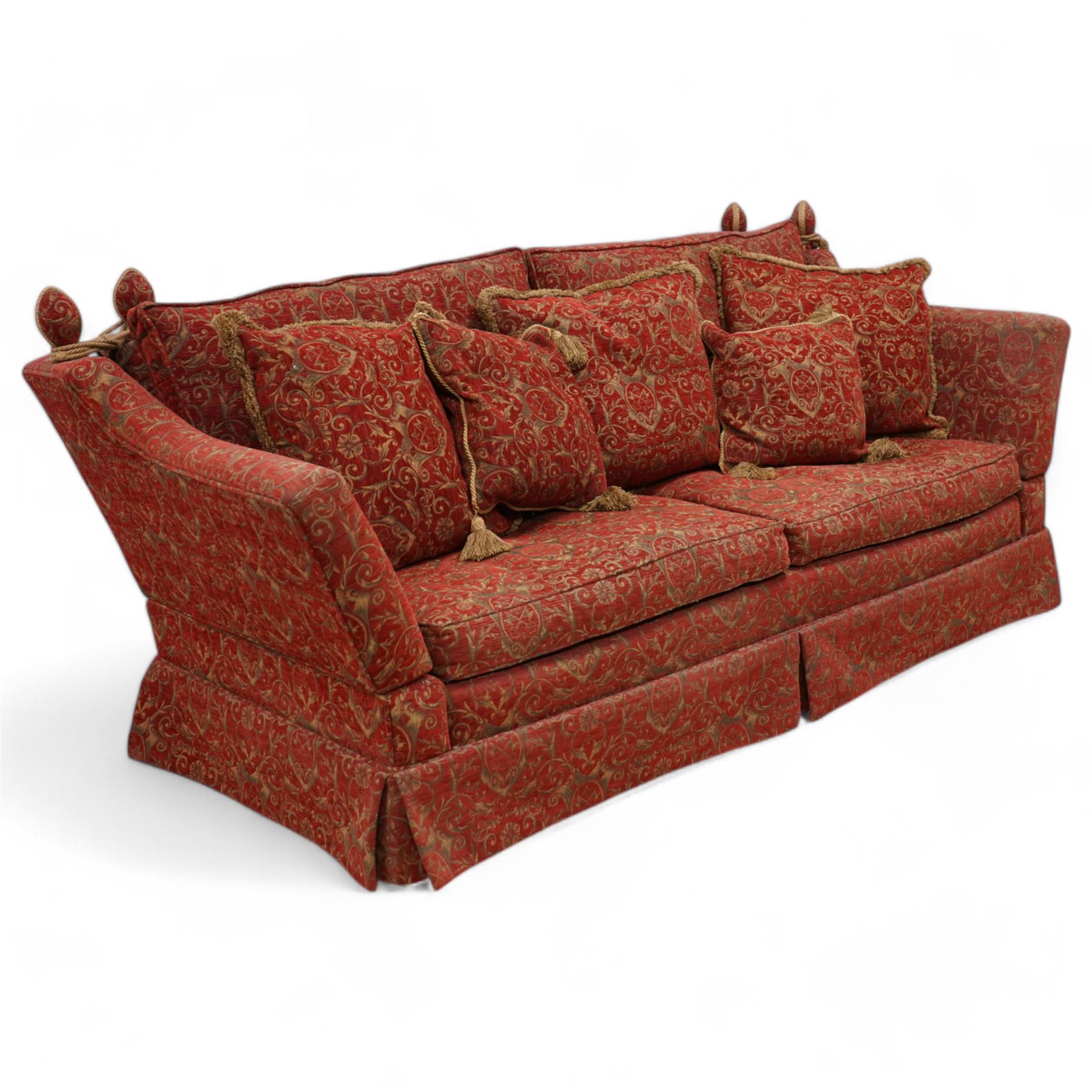 Large Knole design hardwood-framed three-seat drop-arm sofa, upholstered in crimson fabric decorated with trailing acanthus leaves and shields, together with scatter cushions 