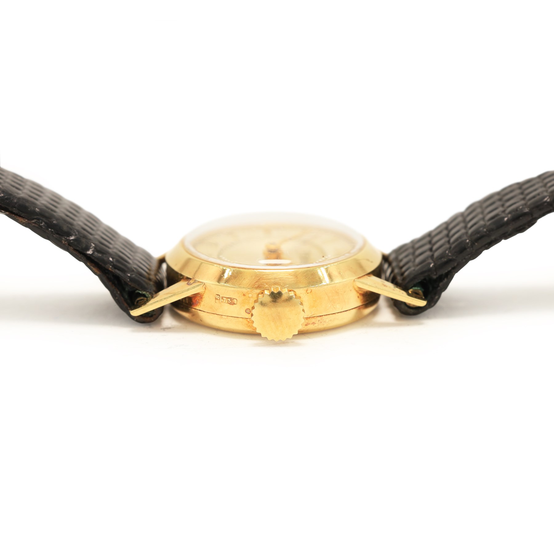 Piaget ladies 18ct gold manual wind wristwatch, silvered / champagne engine turned dial with dagger hour markers, back case No. 5635, Birmingham import mark 1956 with Helvetia hallmark, on black leather strap