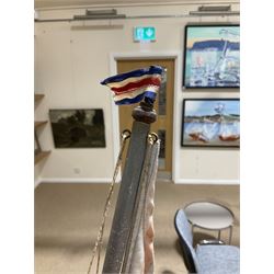 Large pond yacht with simulated planked mahogany deck, mahogany hull, wooden keel and stern fin and tubular aluminium mast with two sails; on wooden stand L131cm H on stand 177cm