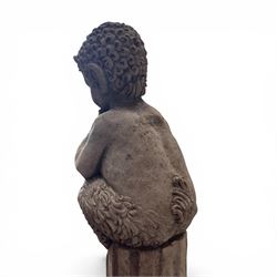 Pair of weathered composite stone garden figures, modelled as a girl and a young satyr playing the panpipes seated on column supports, the fluted columns with climbing ivy vines and surmounted animal, butterfly and other zoomorphic motifs