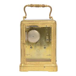 Late 19th century French 8-day brass cased carriage clock, Henry Marc of Paris, the gorge case with swing handle and four bevelled glass panels, white enamelled dial with Roman numerals and minute markers and steel hands, the two train movement with platform lever escapement, hour striking on a bell, with key