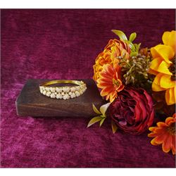 18ct gold diamond heart bangle, two rows of eleven graduating heart motifs, each set with pave set diamonds, spaced by ten round brilliant cut diamonds, total diamond weight approx 1.90 carat