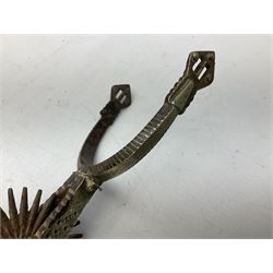 Pair of late 19th century South American iron spurs, engraved silver mounts, with sunburst rowls