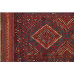 Near pair of Afghan Meshwani runner rugs, each with four red lozenge medallions on a blue ground interspersed with hooked geometric motifs, enclosed by patterned red borders, striped kilim end panels (2)