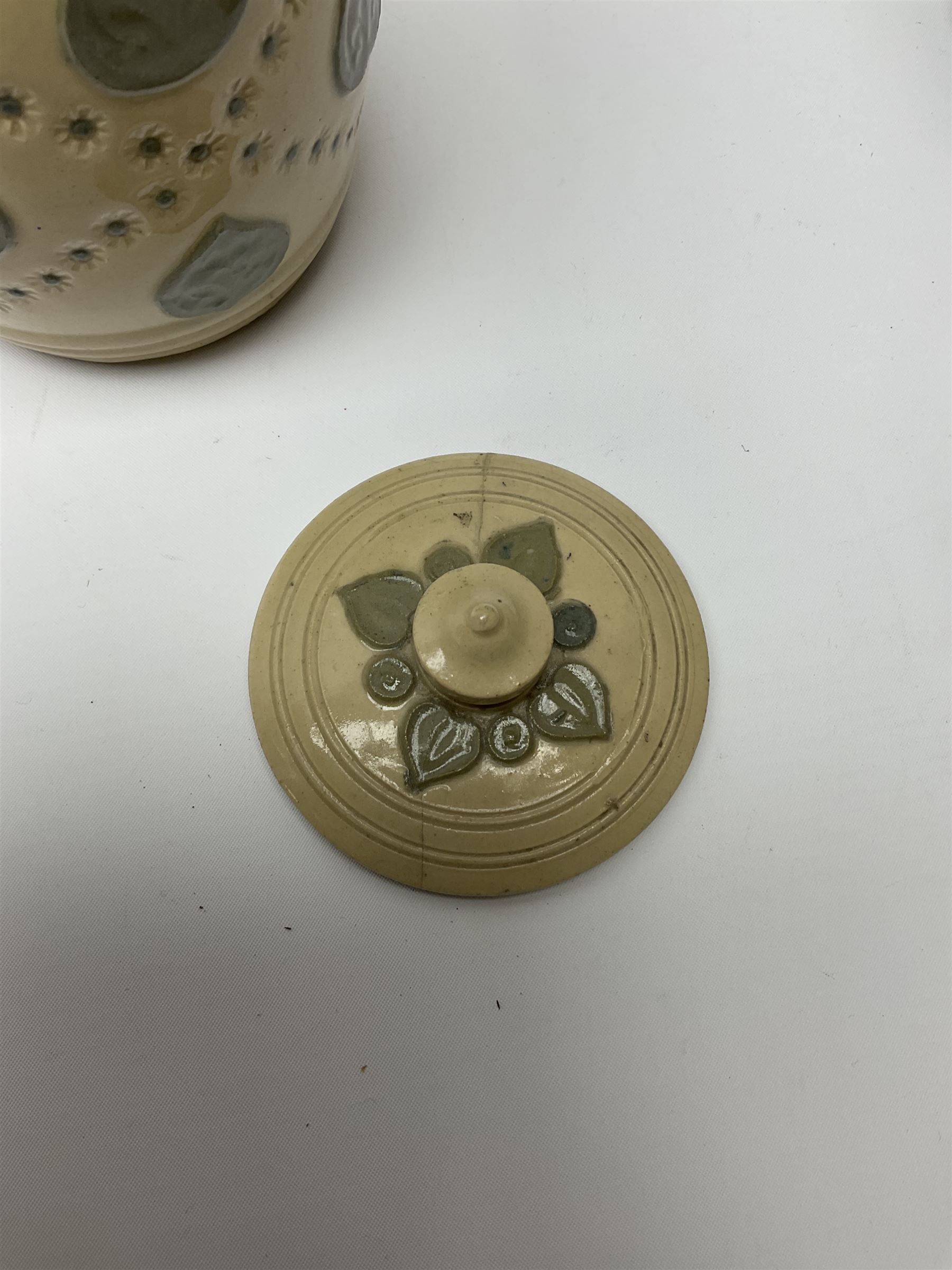 A group of Doulton Lambeth and Royal Doulton tobacco jars, to include examples with relief moulded foliate decoration, each with impressed marks and markers monograms beneath. 