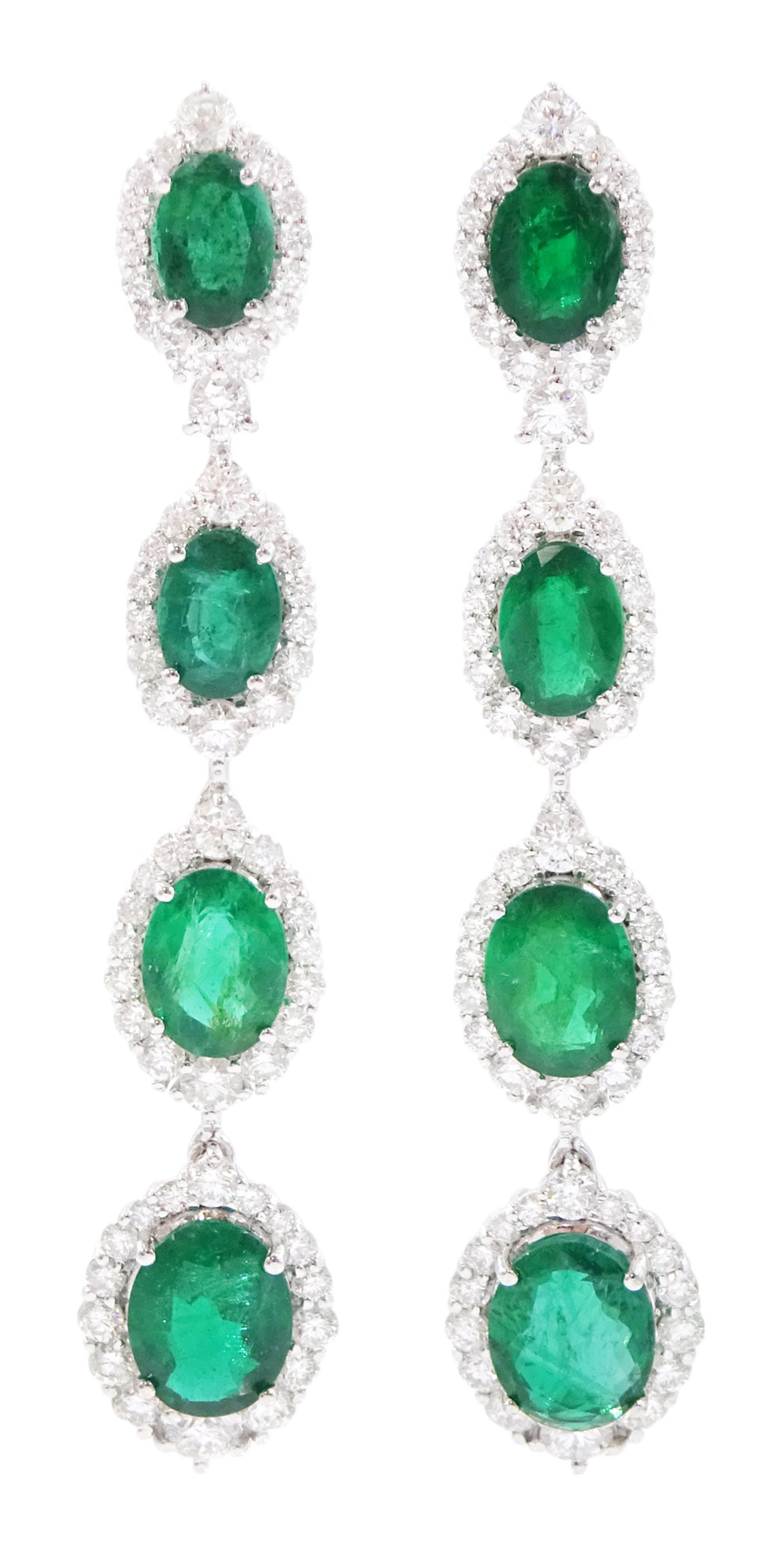 Pair of 18ct white gold graduating emerald and diamond pendant stud earrings, oval cut emerald and round brilliant cut cluster, suspending a single round brilliant cut diamond and three further emerald and diamond clusters, stamped, total emerald weight approx 8.65 carat, total diamond weight approx 3.30 carat