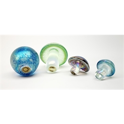 Three John Ditchfield Glasform iridescent mushroom paperweights, two with paper labels beneath, largest H9cm, together with a John Ditchfield Glasform apple paperweight, in iridescent blue, with paper label beneath. 