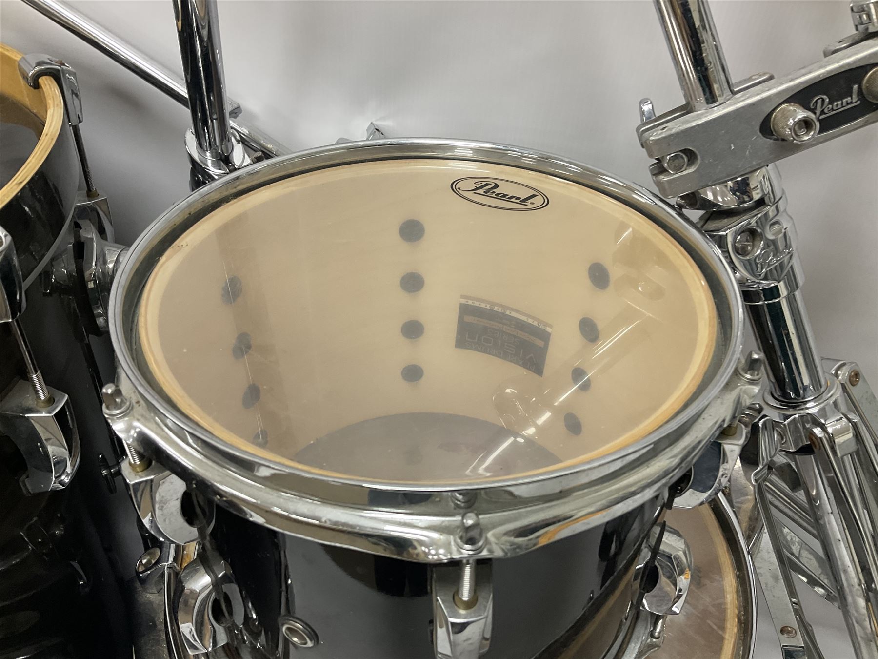 Pearl Vision SST Birch Ply shell four-piece drum kit in black comprising bass drum with foot pedal and three graduated toms; together with Pearl Custom Alloy Sensitone steel snare drum, drum and cymbal stands, microphone stand, stool and various drum sticks 