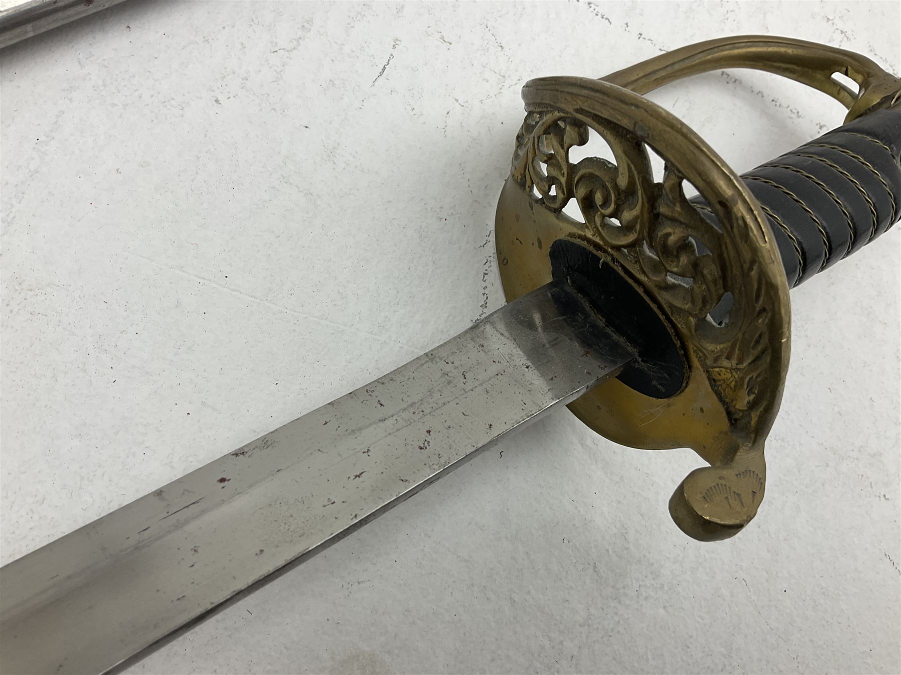 Reproduction American Civil War Cavalry trooper's sword, the 88cm slightly curving fullered steel blade marked to the ricasso 'Ames & Co Chicopee Mass.' and 'US ADK 1862'; brass hilt and leather covered grip; in steel scabbard L110cm overall;  and another reproduction sword (2)
