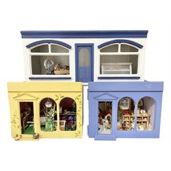 Three scratch-built wooden shop dioramas - single room Pet Shop with hinged front, fully furnished and well stocked with animals, birds and numerous accessories; and matching Garden Shop, fully furnished and well stocked with fruit, vegetables and garden accessories including lawn mower, wheelbarrows etc; each W34cm H27cm D26cm; and double fronted single room Butchers Shop with butcher at his block, partially stocked counter and two delivery cycles W57cm (3)