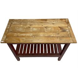Pine kitchen table, rectangular bread boarded plank top over red painted splayed supports and pot board base