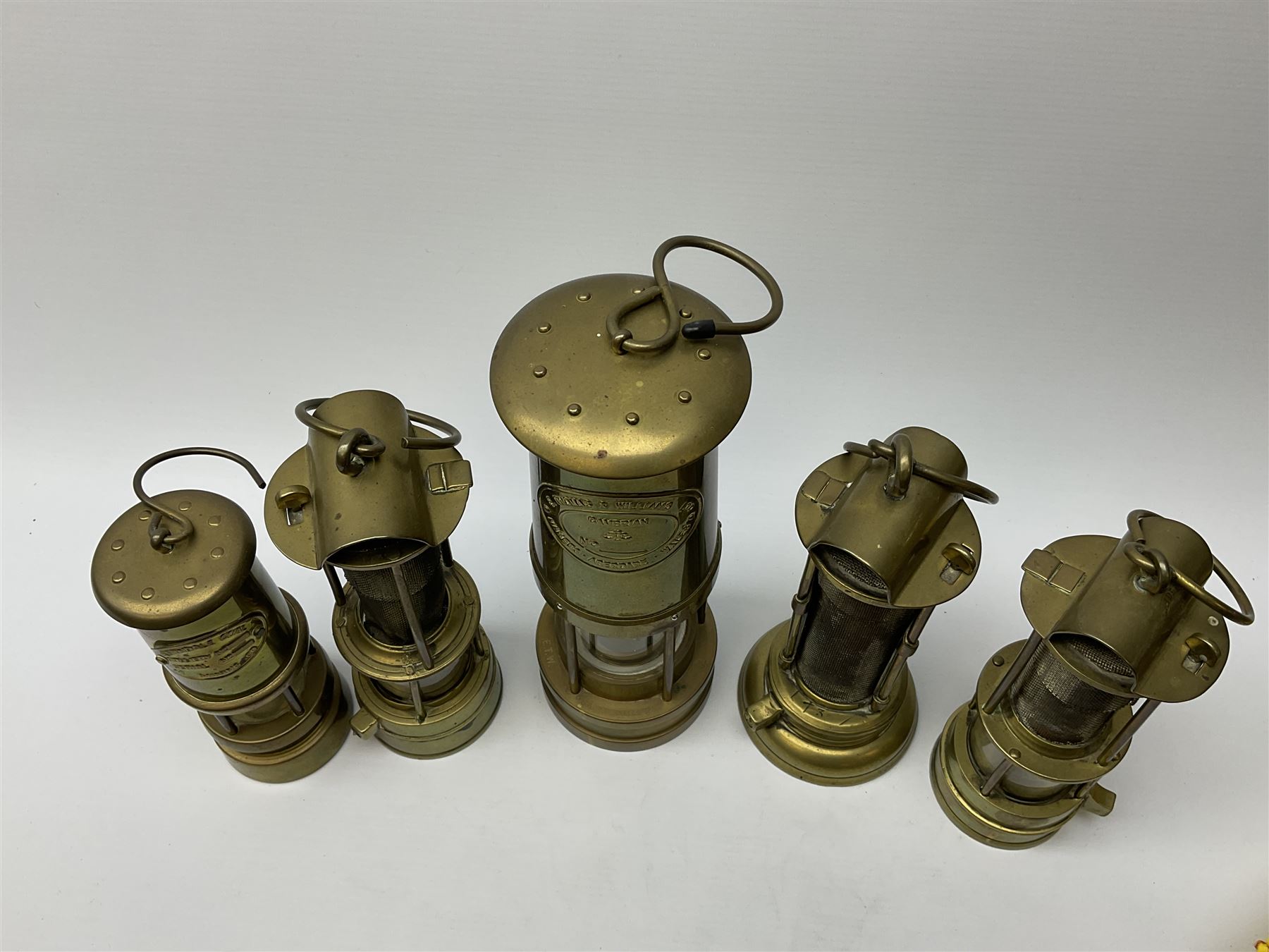 A collection of five mining lamps, to include examples by F Thomas & William Ltd, H25.5cm, Ferndale Coal, 18cm, and Daidler Durham, H21cm, plus two unmarked examples.