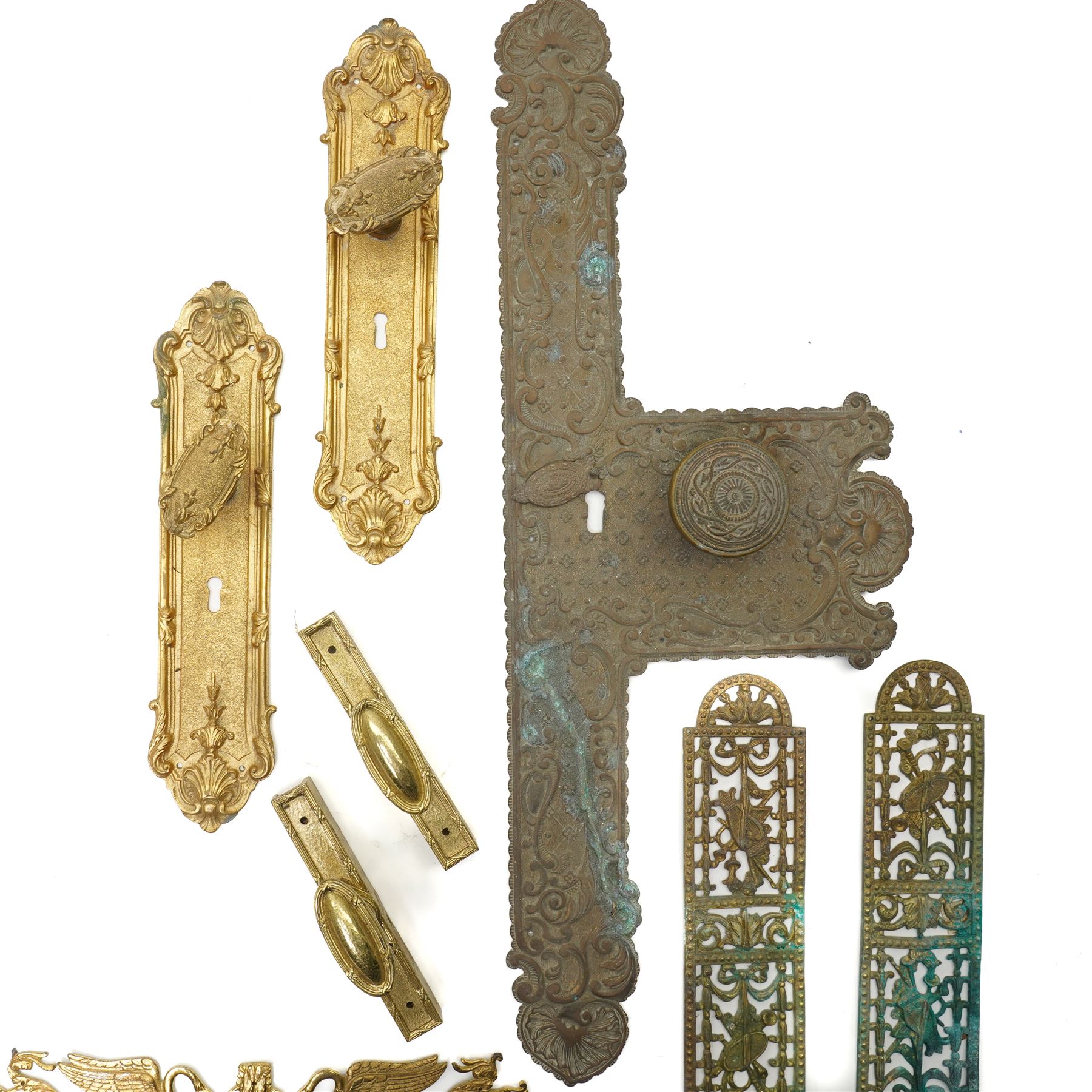 Large Victorian embossed brass door plate by Turner & Fowle with circular handle L63cm , pair of period design gilt brass door plates with oval handles, two more pairs of brass door plates and pair of brass door handles  
Provenance: property of a Nobleman