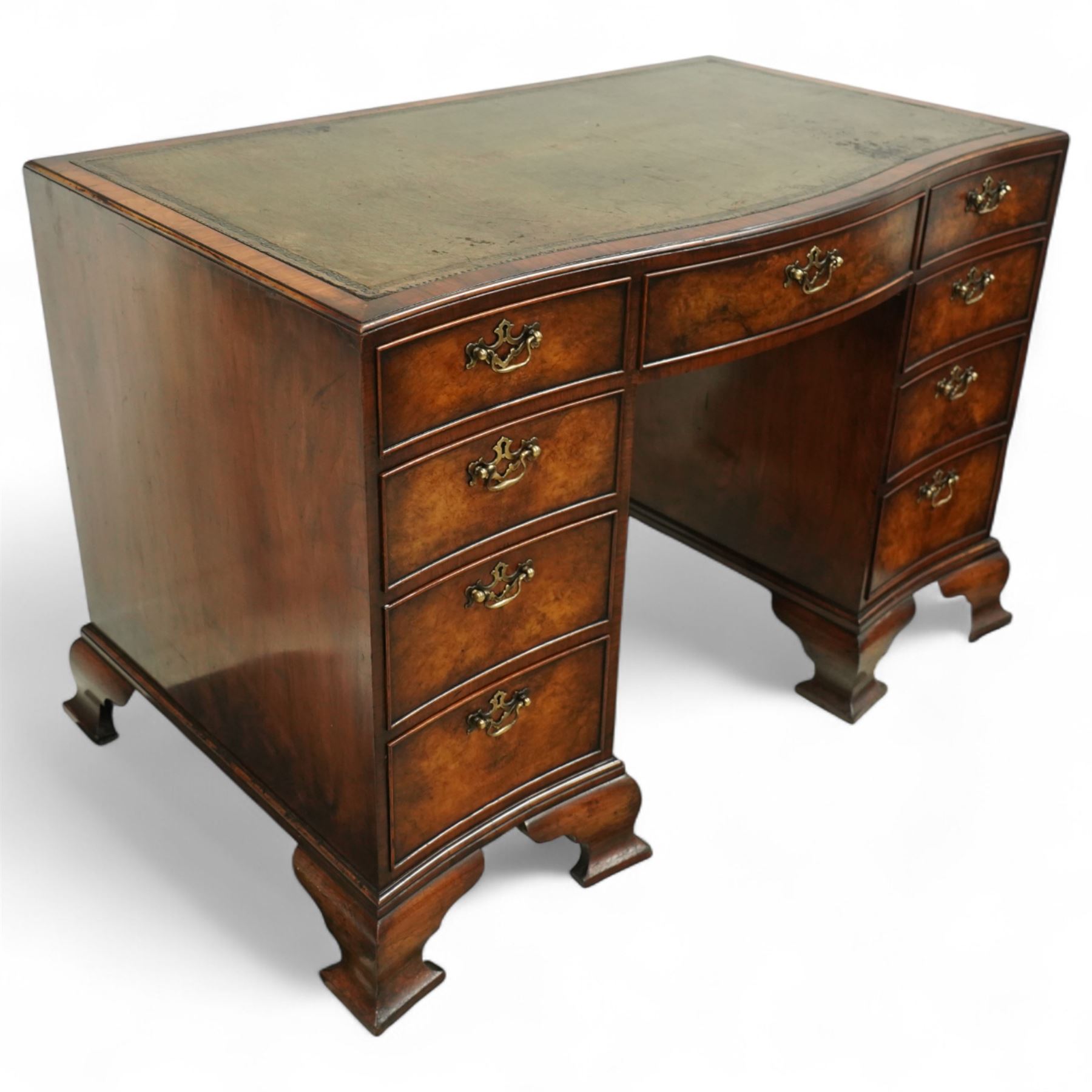 Early 20th century inlaid mahogany pedestal kneehole desk, rectangular top with inset tooled leather writing surface, over an arrangement of nine drawers with brass swan neck handles, on ogee bracket feet