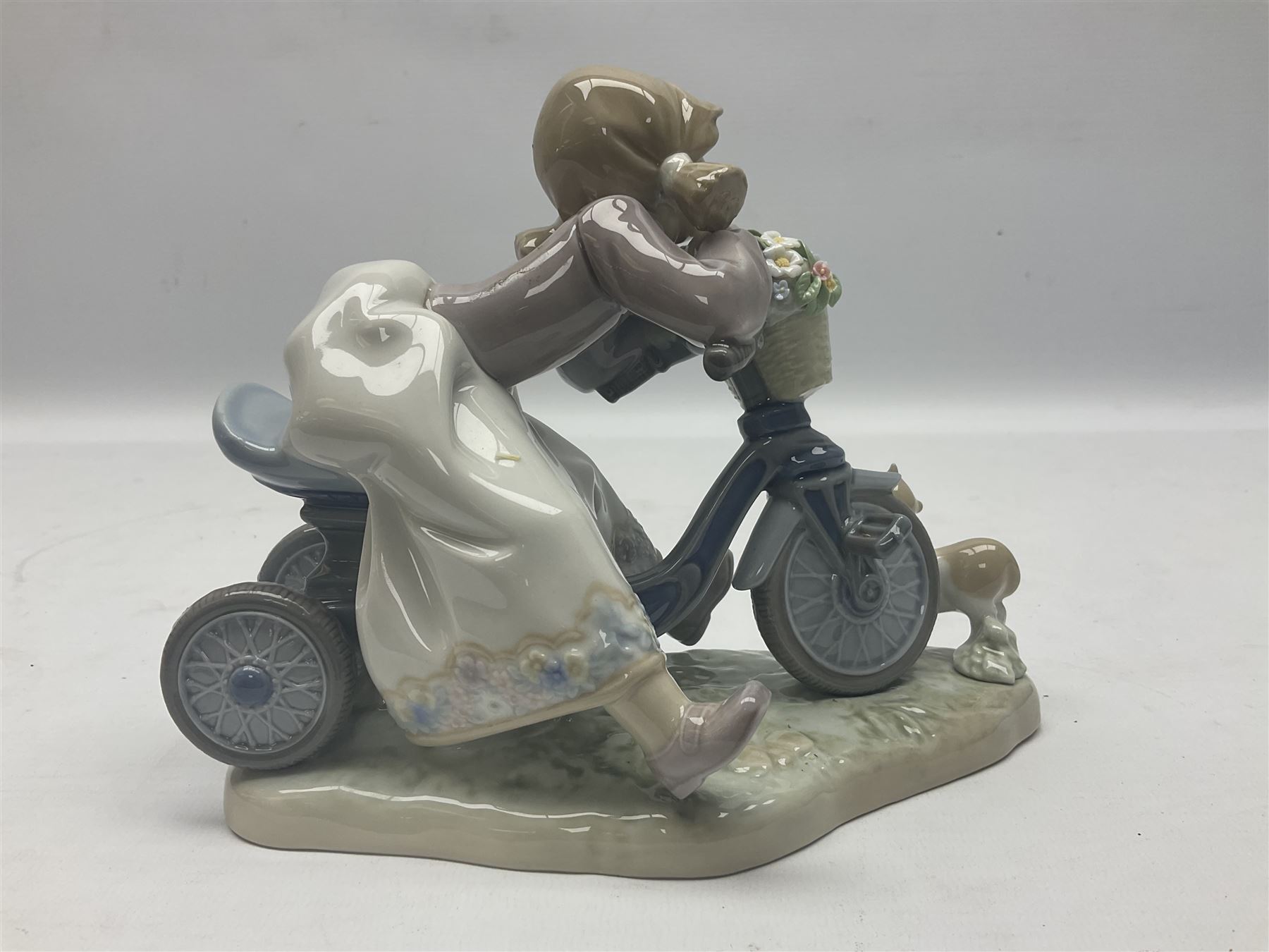 Lladro figure, In No Hurry, modelled as a girl on a tricycle, sculpted by Francisco Polope, with original box, no 5679, year issued 1990, year retired 1994, H15cm