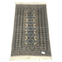 Persian style beige ground rug, repeating borer, 140cm x 87cm