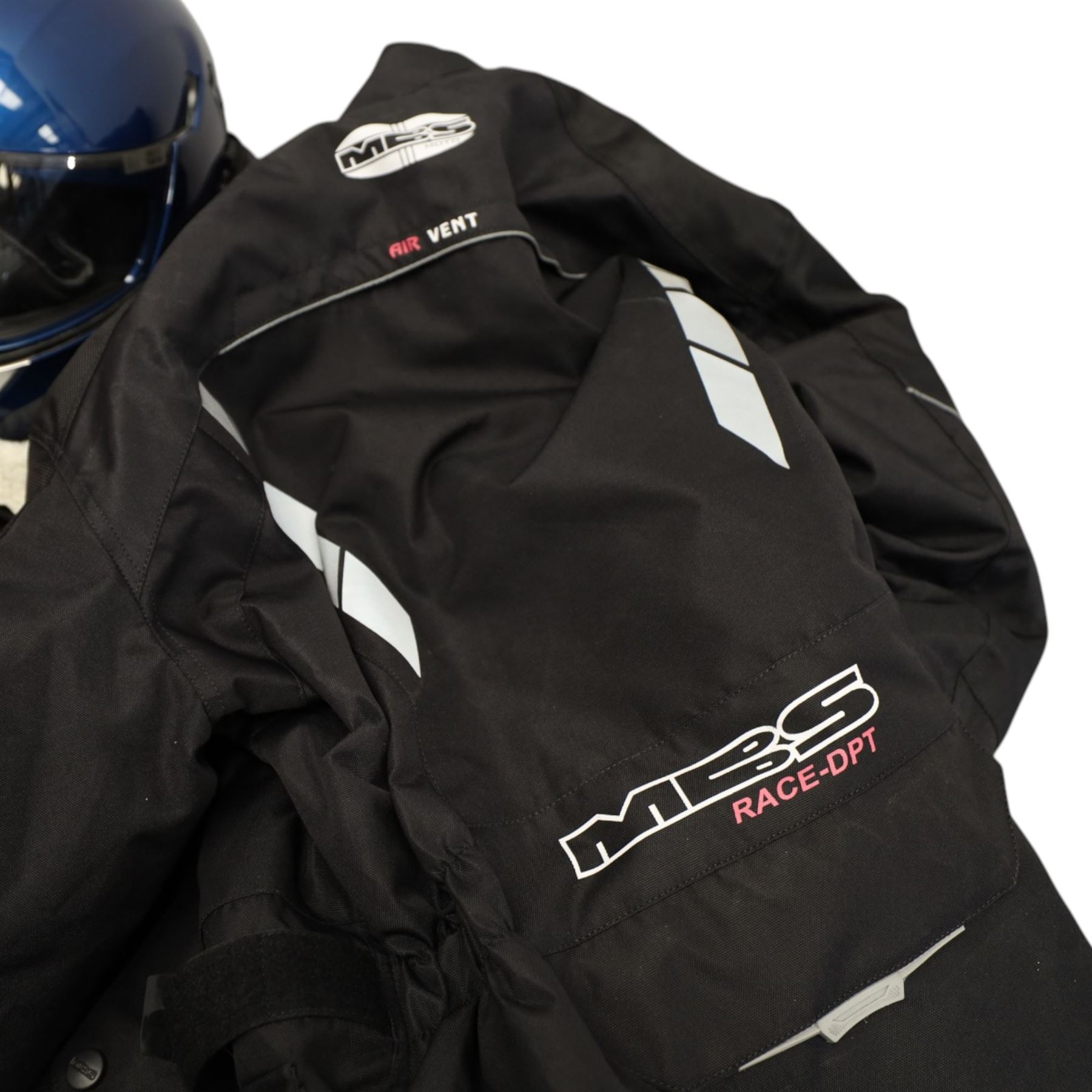 Collection of motorcycle clothing including MCS jacket, two pairs of gloves and two helmets 