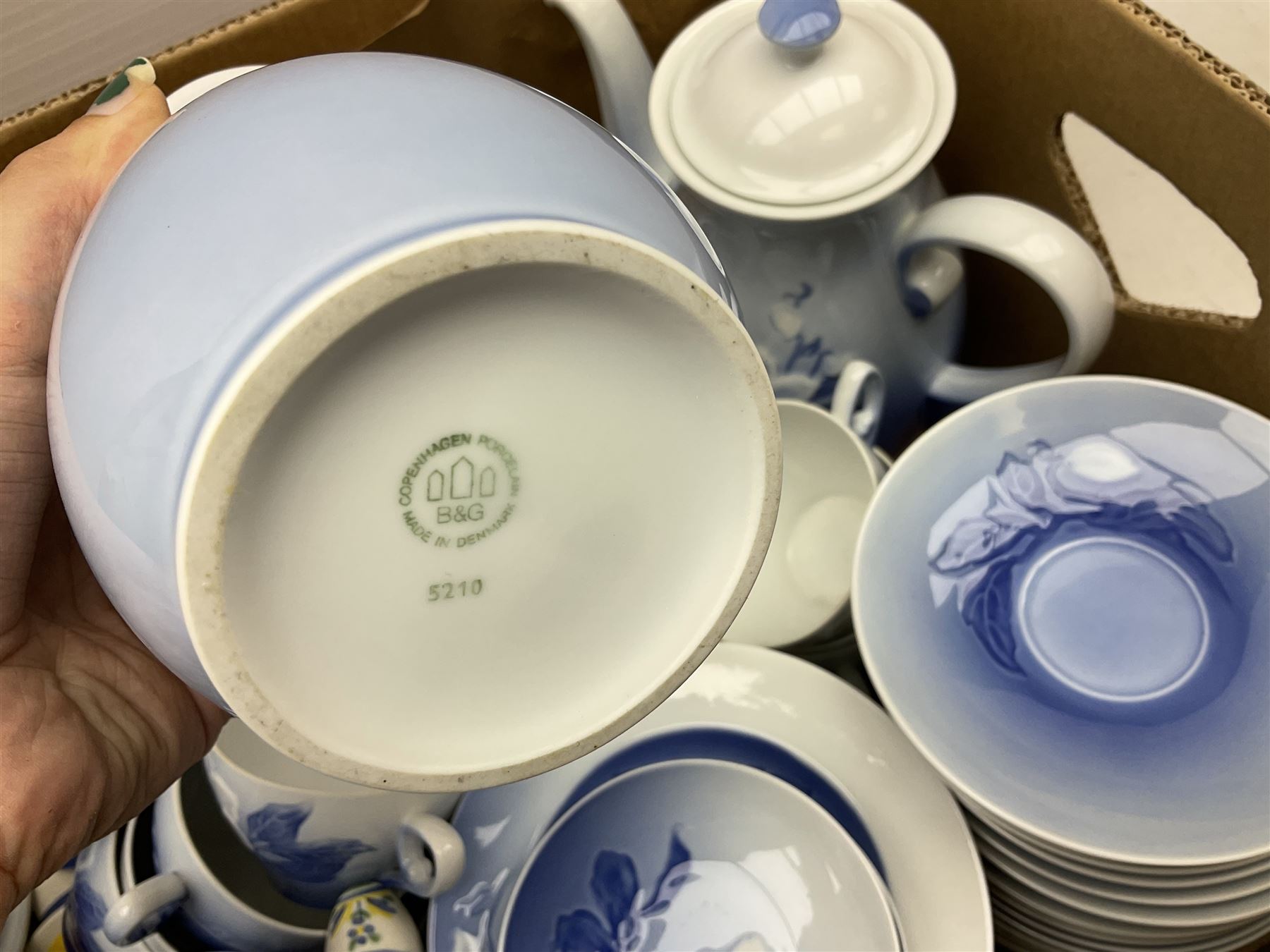  Bing & Grondahl, Copenhagen blue and white Christmas Rose pattern tea wares, to include teapot, covered sucrier, milk jug, fourteen cups and seventeen saucers, etc, together with two Royal Copenhagen collectors plates etc  