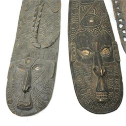 Papua New Guinea Middle Sepik carved sago plate with crocodile head handle L81cm, two Sepik masks/wall hangings inset with cowrie shells, larger 90cm and a small mask (4)