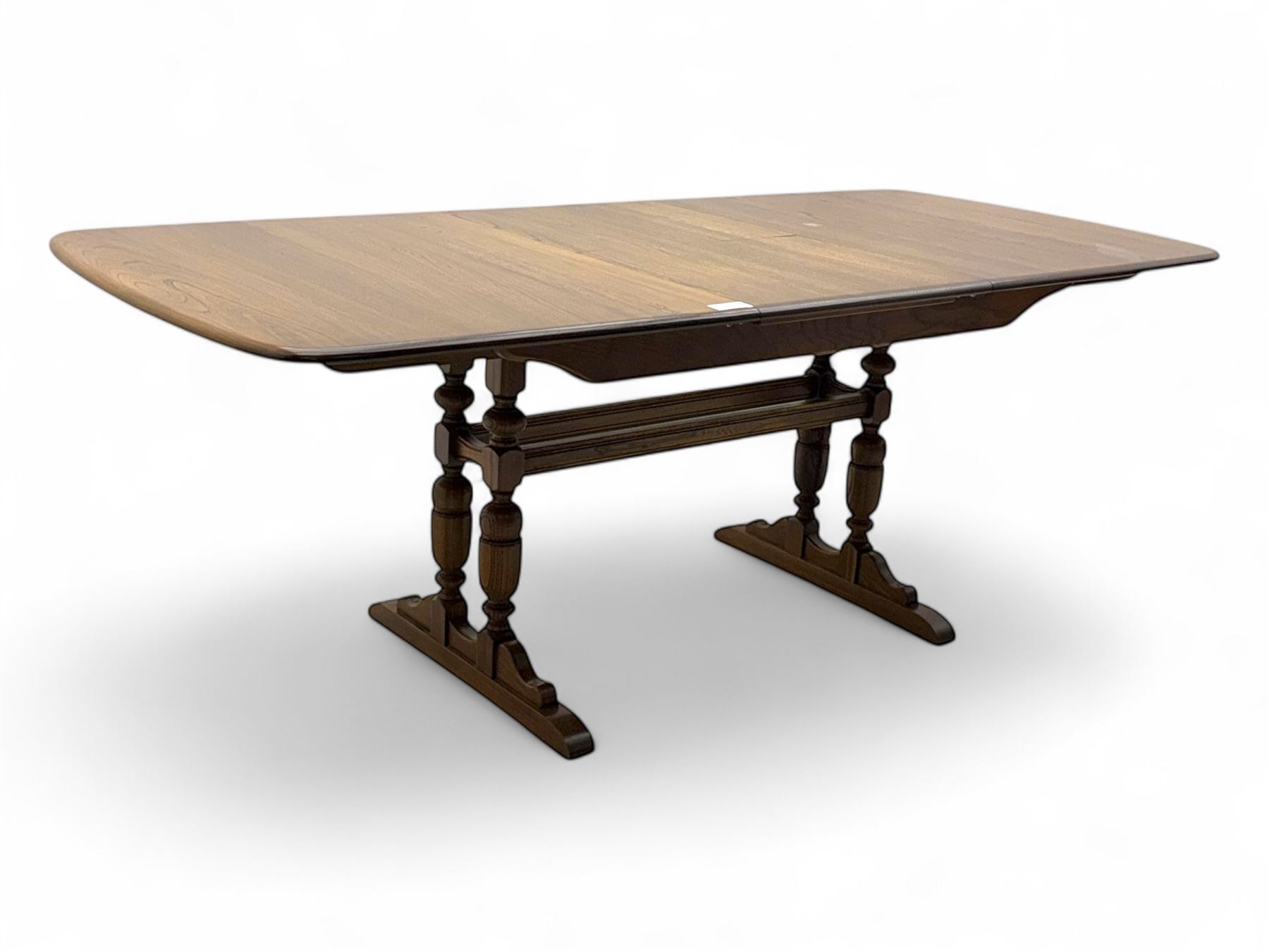Ercol - late 20th century oak refectory dining table, rectangular top with rounded corners and central extending leaf, raised on turned baluster supports united by a stretcher (Extended 200cm)