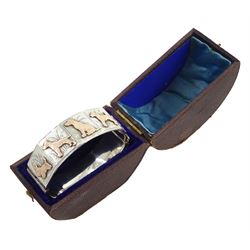 Early - mid 20th century silver dog bangle, five panels with applied rose gold dogs including West Highland Terrier, Labrador and Dachshund, Chester 1940, in velvet and silk lined box