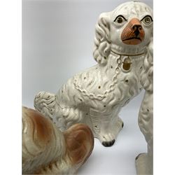 A pair of Victorian Staffordshire white glazed spaniels H34cm, together with a pair of Victorian Staffordshire brown and white glazed spaniels H35cm. 