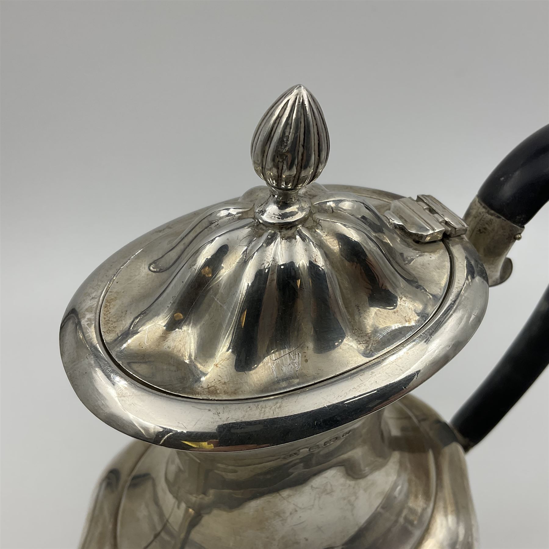 Five piece Edwardian silver tea service, comprising teapot and coffee pot, each with ebonised scroll handle, tea caddy with hinged cover, twin handled open sucrier, and milk jug, each of rounded bombe form, upon four paw feet, hallmarked William Adams Ltd, Birmingham 1904 and 1905, coffee pot H26cm
