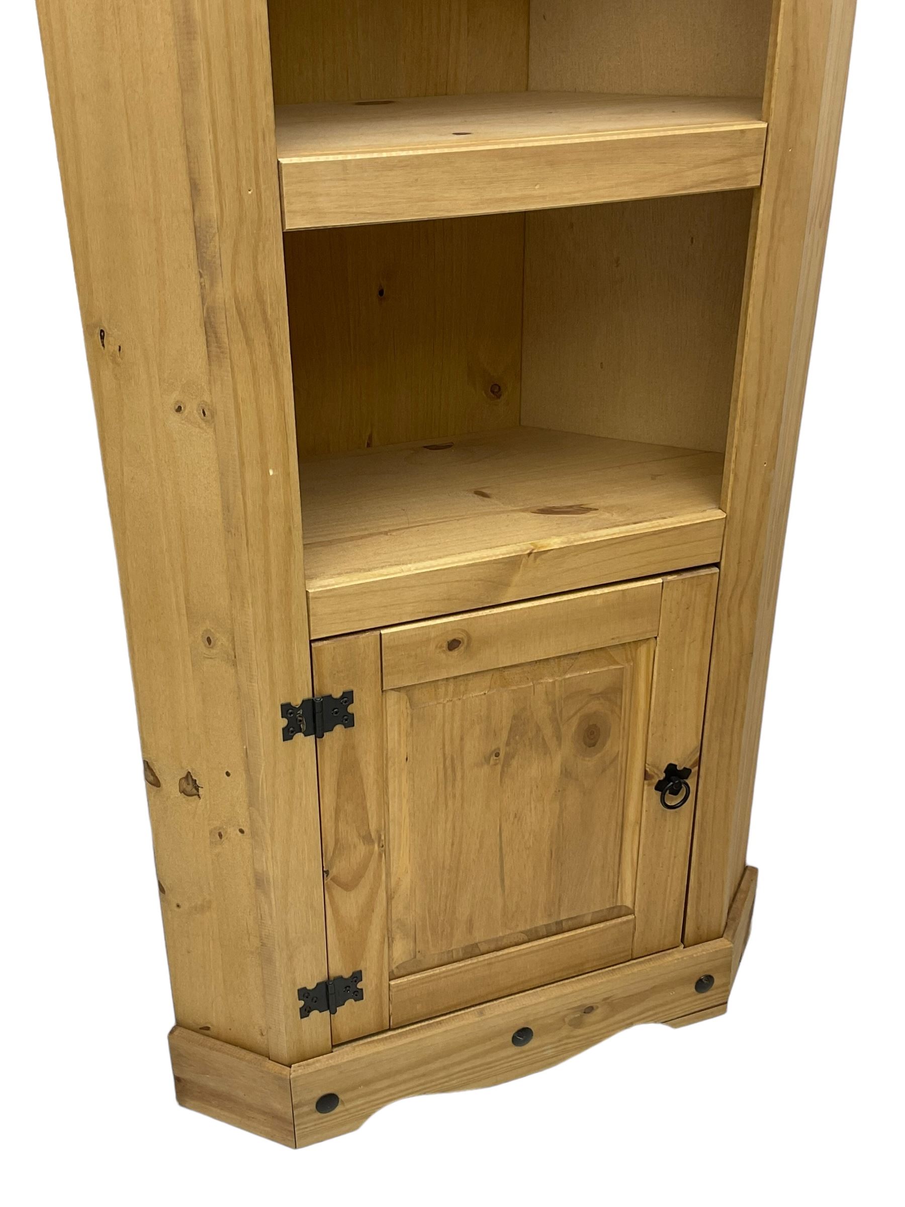 Pine media or television cabinet, enclosed by single glazed door (W56cm, H82cm, D43cm); pine corner cupboard, three shelves over single cupboard (W76cm, H188cm); pine two-tier plate rack with shaped frieze and uprights (W113cm, H107cm)