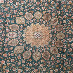 Persian Tabriz type carpet, the teal ground decorated with central medallion, radiating palmettes and dense floral scrollwork, within multiple floral borders