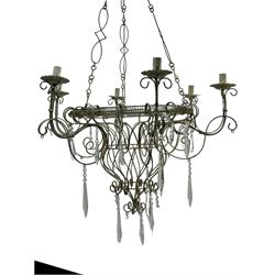 India Jane Interiors - six branch metal chandelier, the scrolled crown over circular bulbous body with six projecting branches, decorated with scroll work and glass pendants, in distressed white paint finish - ex-display/bankruptcy stock 