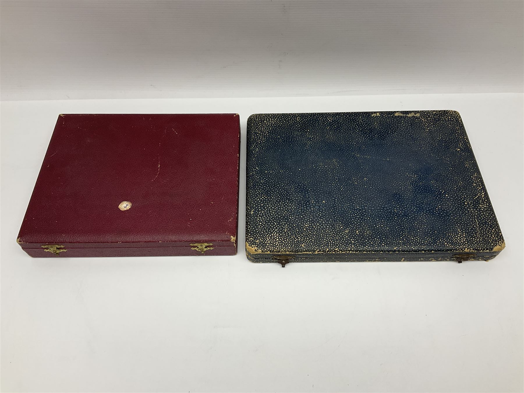 Set of six stag horn handled knives by Cooper Brothers and Sons, together with a set of silver plated dessert knives and forks for six place settings, both within fitted cases