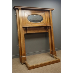  Arts & Craft period oak fire surround, projecting cornice, inset oval mirror, above shelf, square columns pilasters, and fender, W153cm, H181cm, D24cm  