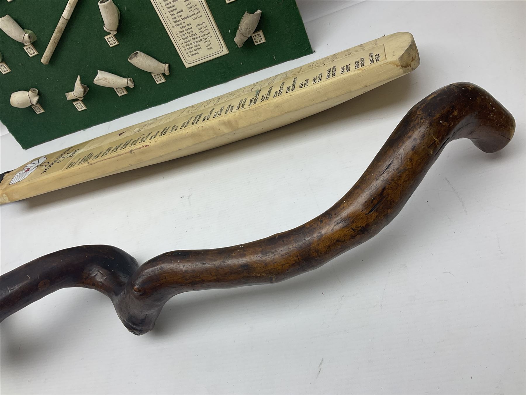 Annotated display board of clay pipes; rootwood walking stick and Yorkshire CCC signed cricket bat 2001