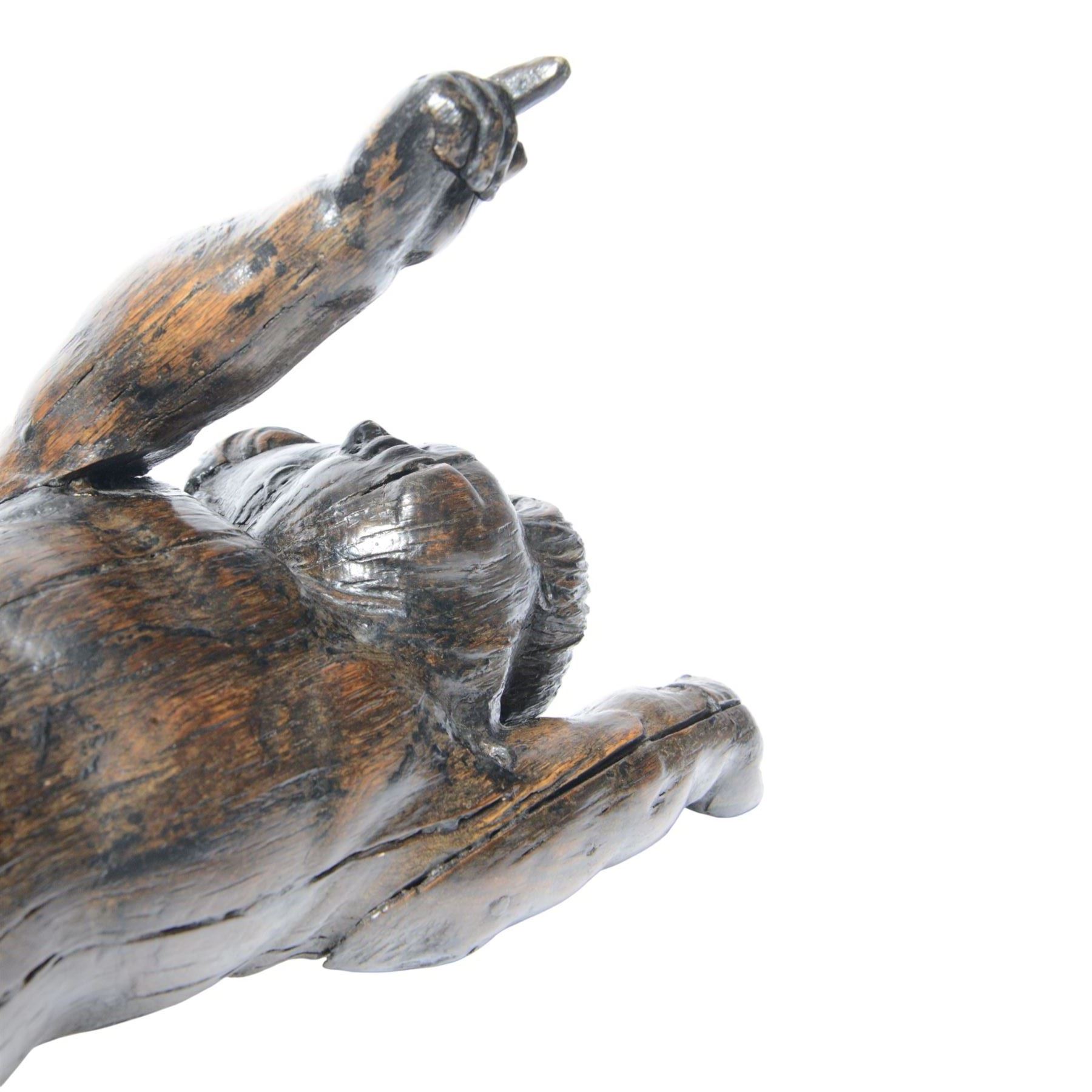 17th century carved figure of a putto, modelled with arms upstretched and head turned, approximately H64cm W23cm D27cm