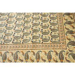 Central Persian Kashan hand-knotted carpet, ivory field densely decorated with all-over repeating botehs motifs, arranged in rows and enclosed by scrolling vine work and floral sprays, in a palette of indigo, pale blue, sage green and muted terracotta tones, within ivory borders of small boteh motifs flanked by border within large scale boteh motifs with multiple guard stripes, with cotton fringe ends 