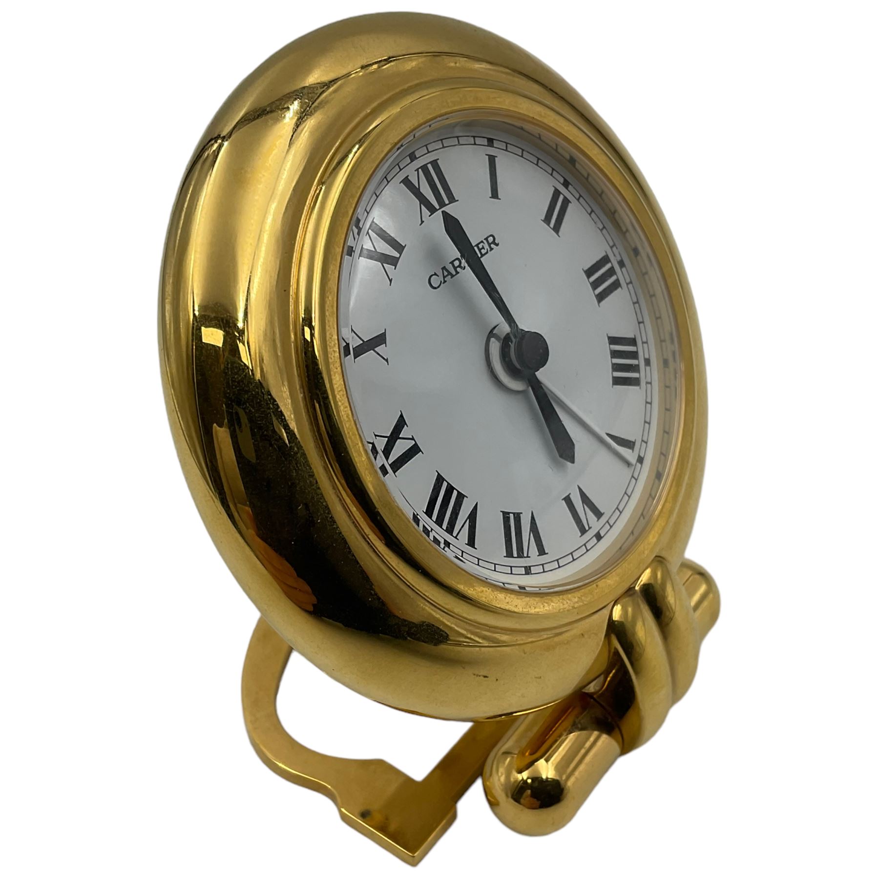 Cartier, Pasha de Cartier desk/travel clock, of circular form with gilt finish and white dial, with quartz movement, inscribed verso Made in France, Cartier Paris, serial no 0541616, dial D5cm, clock H9.7cm