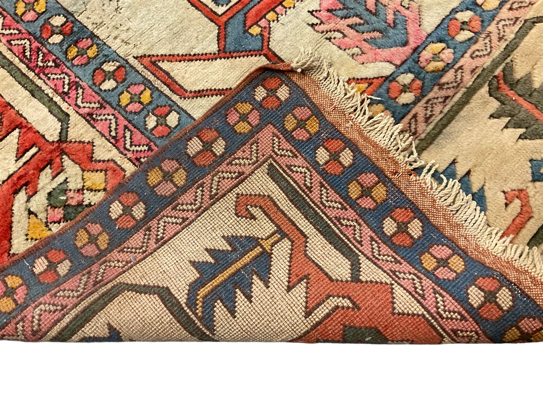 Anatolian Turkish ivory ground carpet, the central geometric pole medallion within an amber field, the guarded border decorated with stylised plant motifs surrounded by bands of repeating flower heads