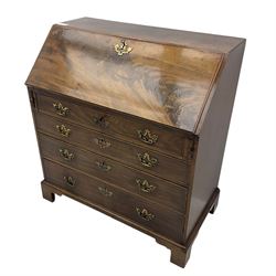 George III mahogany bureau, fall-front enclosing a fitted interior of drawers, pigeonholes and central mirrored cupboard, over four graduated cockbeaded drawers with brass batwing handles, raised on bracket feet