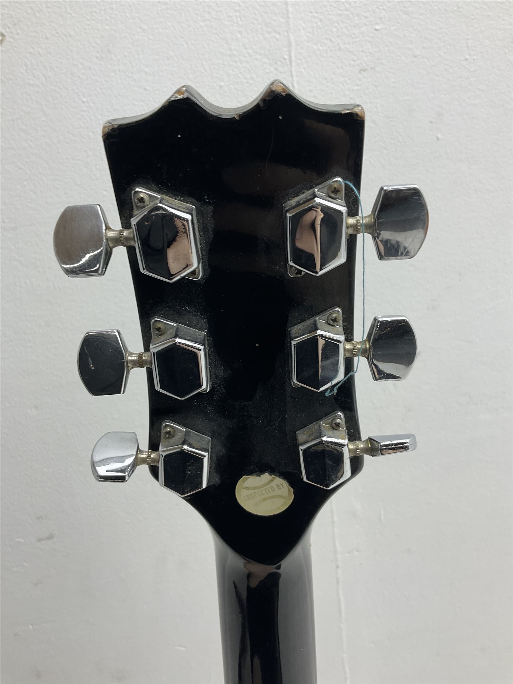 Stagg heavy metal style six-string electric guitar, finished in black with chrome tuning pegs, fret markers and humbucker pickups to bridge L106cm; and Hondo USA electric guitar with black body, ivory coloured pickguard and mother-of-pearl fretmarkers L101cm (2)   