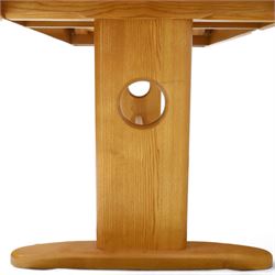 Ercol - 'Windsor' ash medium extending dining table, with stowed fold over leaf extending to 200cm, shaped supports with roundel aperture, united by a stretcher