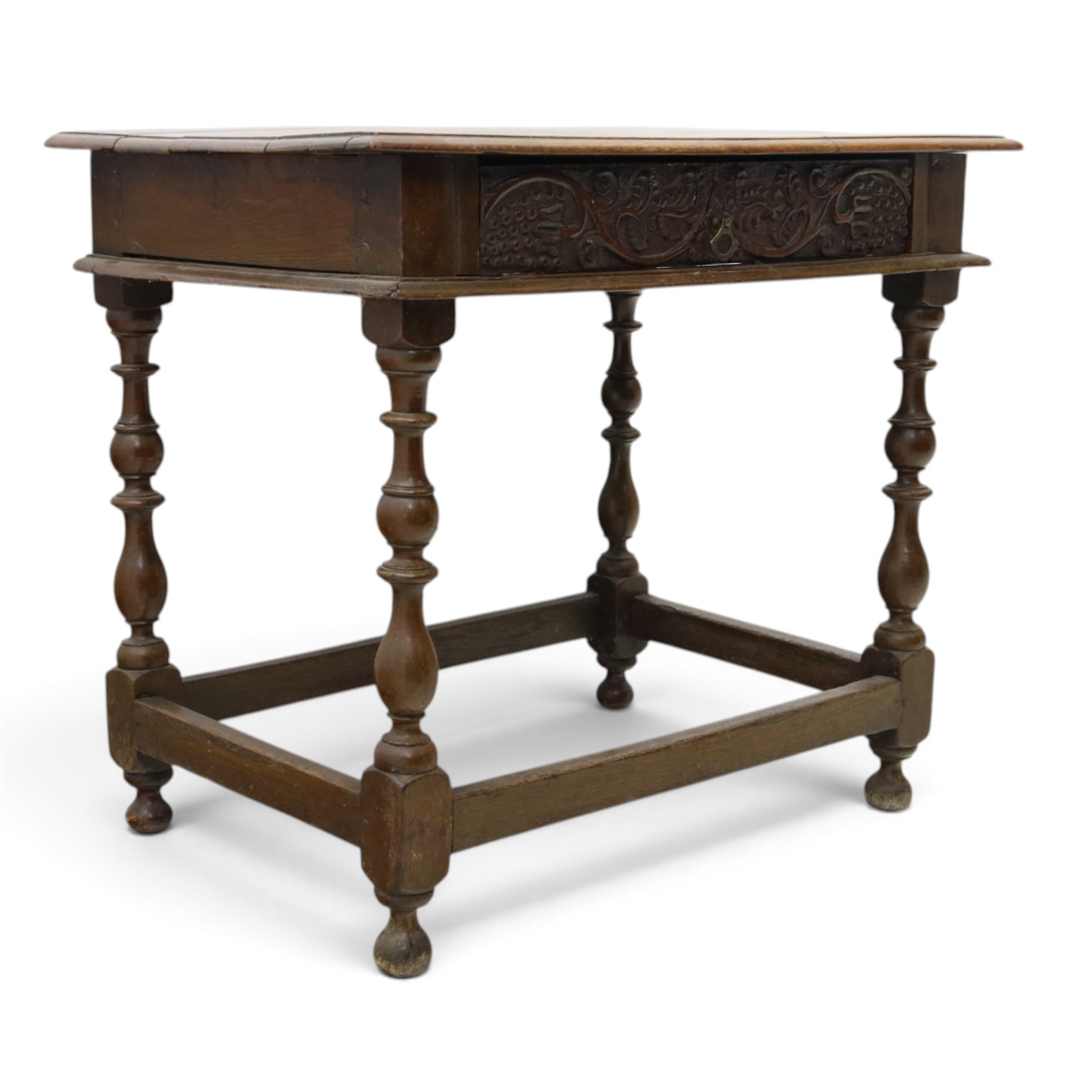 18th century oak lowboy, rectangular top with moulded edge, fitted with single frieze drawer carved with scrolling fruiting vines and stylised plant motifs, raised on bobbin-turned supports united by box stretcher 