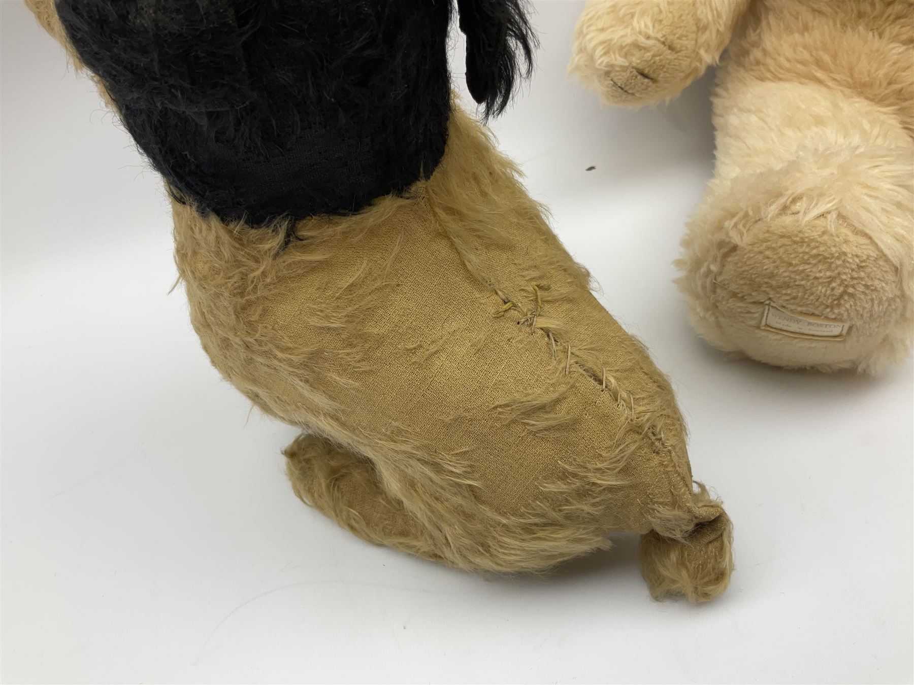 Mid-20th century English plush covered woodwool filled dog with vertically stitched nose and mouth L39cm; and Wendy Boston plush covered teddy bear, the fixed head with applied eyes and vertically stitched nose and mouth H63cm (2)